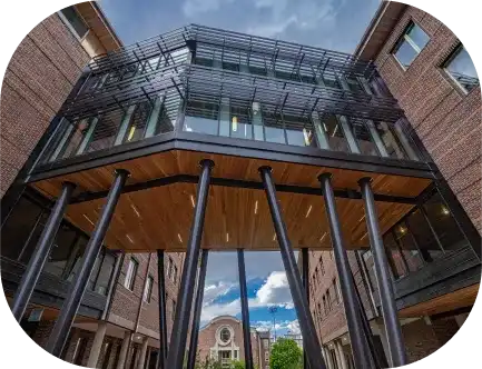 A modern university building at University of Denver with a glass facade and architectural pillars.